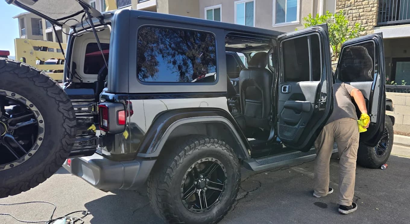 Black Jeep being detailed during a mobile appointment.